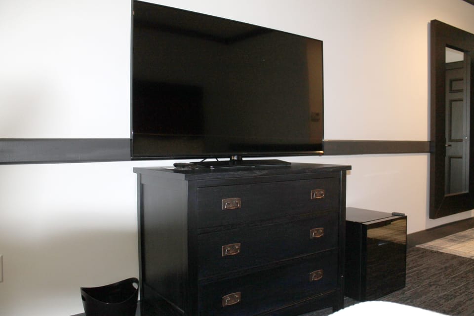 Desk, laptop workspace, blackout drapes, iron/ironing board