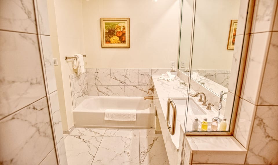 Separate tub and shower, rainfall showerhead, designer toiletries