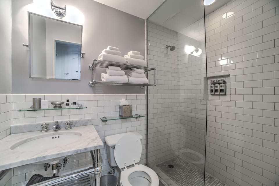 Shower, designer toiletries, hair dryer, towels