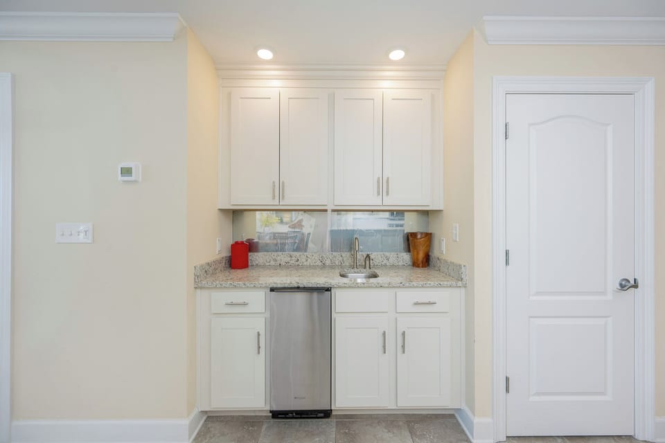 Create refreshing drinks at the sleek wet bar, enhancing your vacation experience with easy access to refreshments