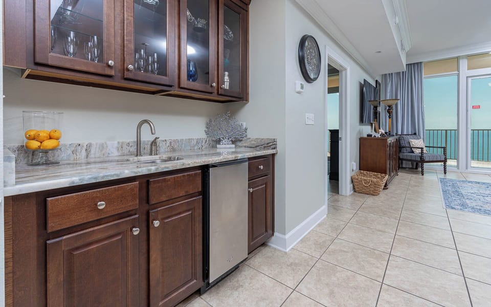 Mix drinks and store refreshments with ease at the stylish wet bar, perfect for entertaining by the coast