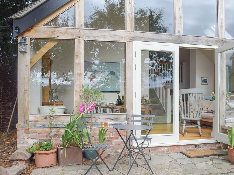 Pretty patio area with seating | The Garden Retreat, Marbury, near Whitchurch