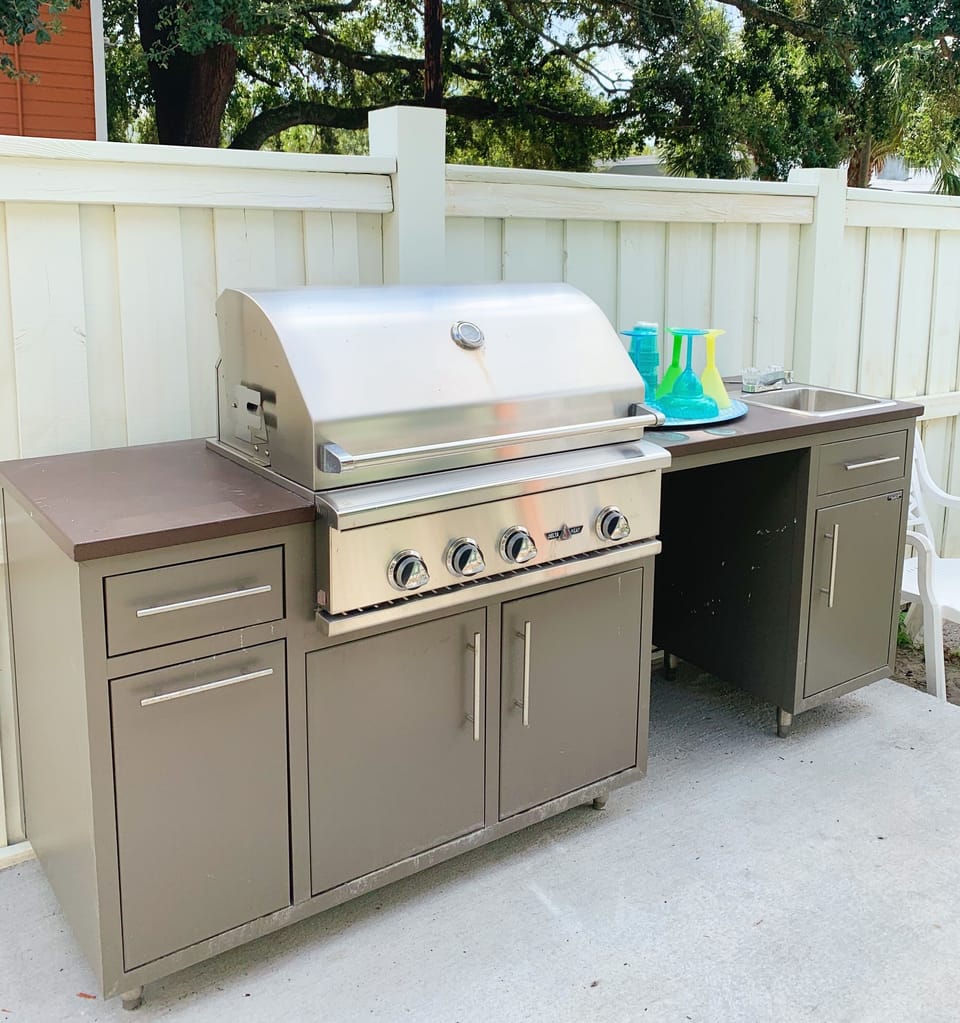 Outdoor grill in back yard, back yard is fenced and private 