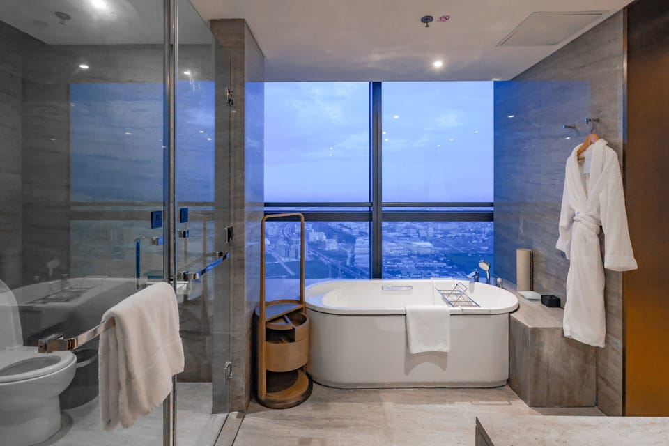 Club Room, 1 King Bed | Bathroom | Separate tub and shower, rainfall showerhead, free toiletries