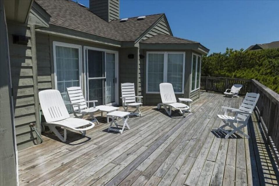 Unwind on your private deck with lounge chairs perfect for soaking up the sun and fresh coastal air, just steps from your cozy retreat.