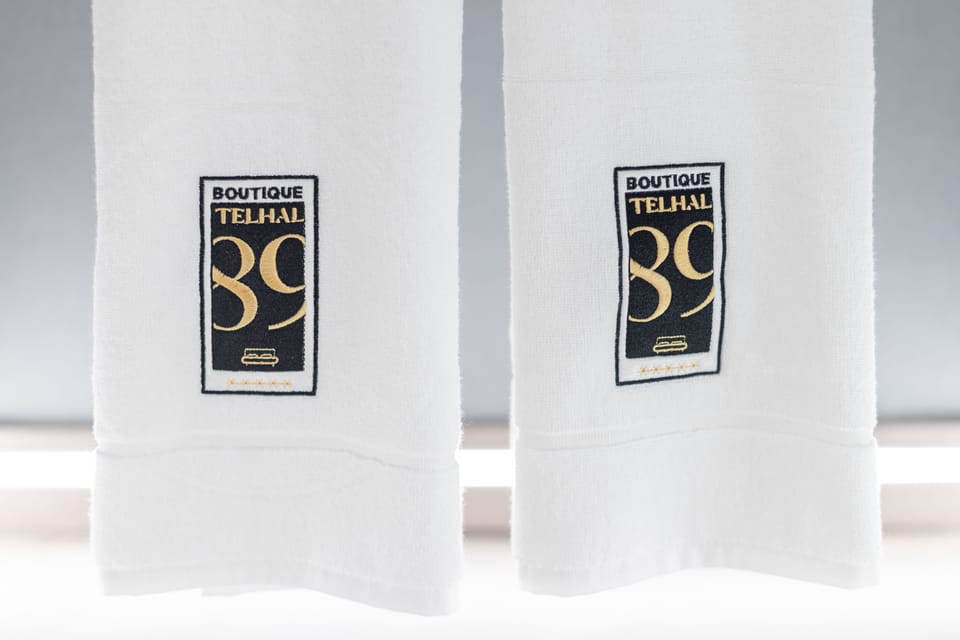 Shower, designer toiletries, hair dryer, towels