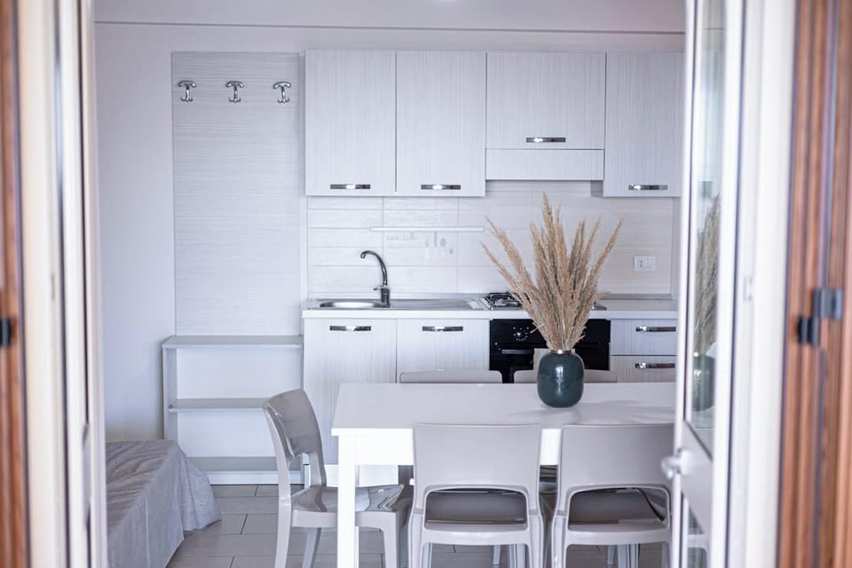 Fridge, stovetop, cookware/dishes/utensils, dining tables