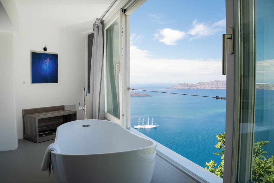 Sun Rocks Experience Suite with indoor Hot Tub, Caldera & Sea View | Pillowtop beds, minibar, in-room safe, desk
