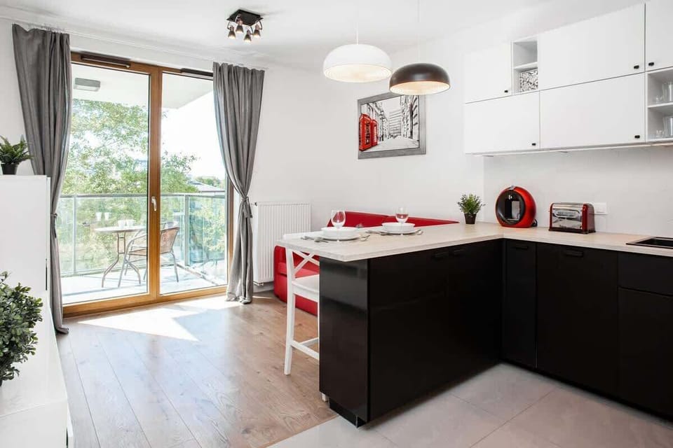 Fully equipped space with red and white color contrast, including all necessary appliances.