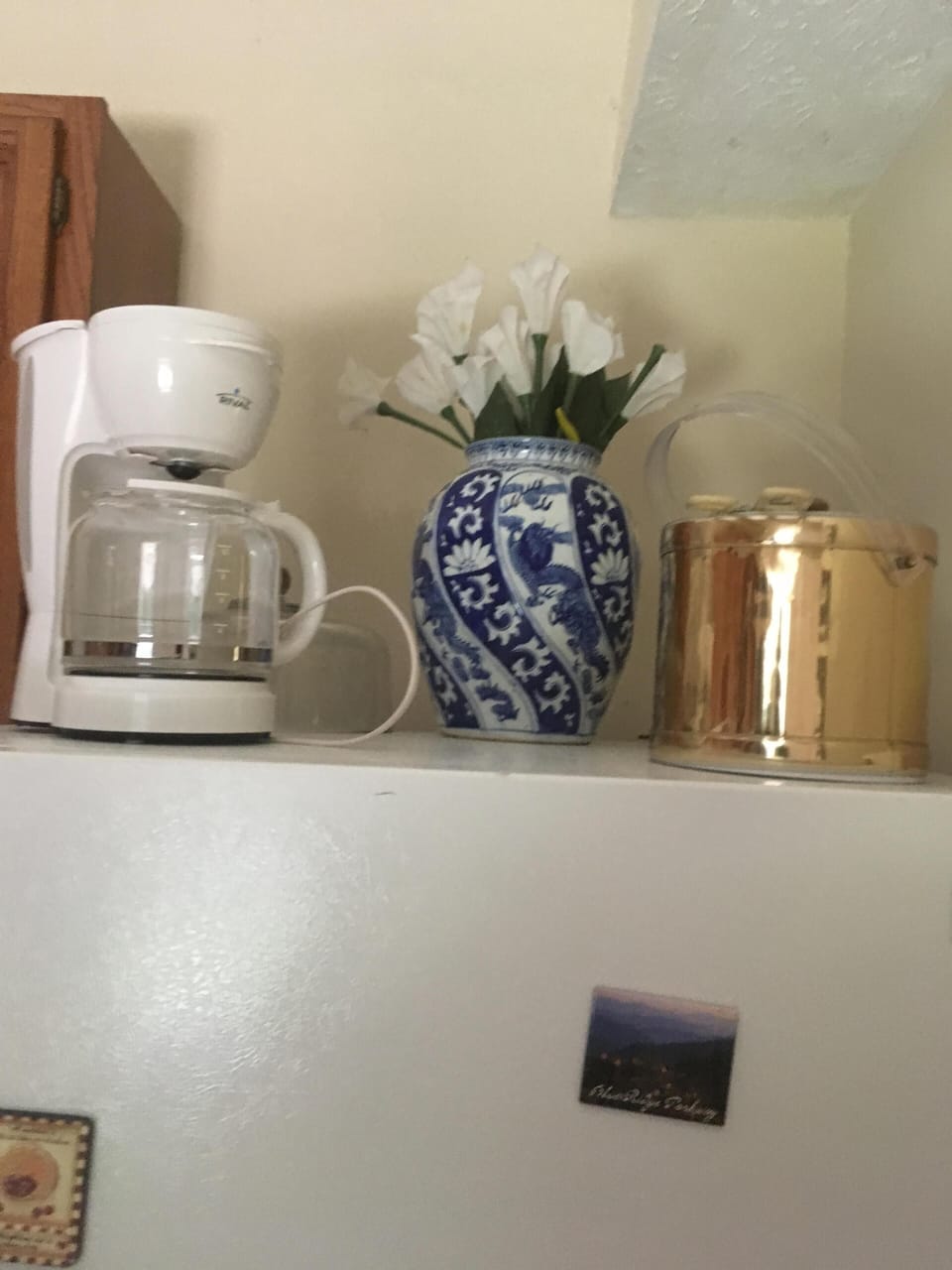 Top of fridge in kitchen/ drip coffee maker & ice bucket