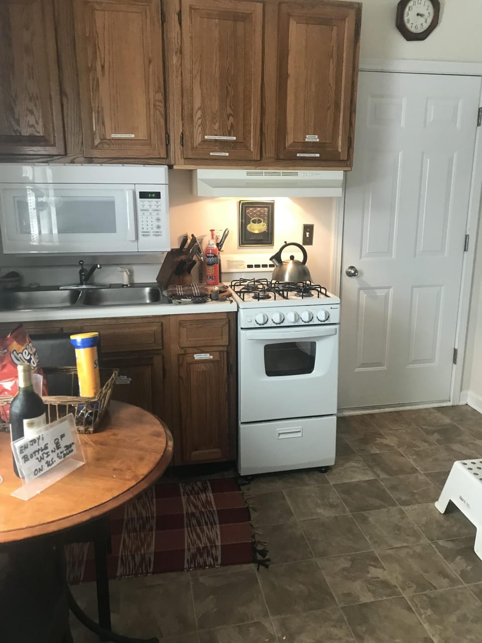 Kitchen stove blutcher block  tea kettle microwave and table / workstatbe .