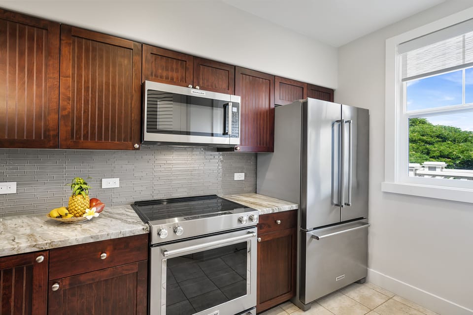 Fully Equipped Kitchen with Marble Counter Tops and Wooden Cabinets
