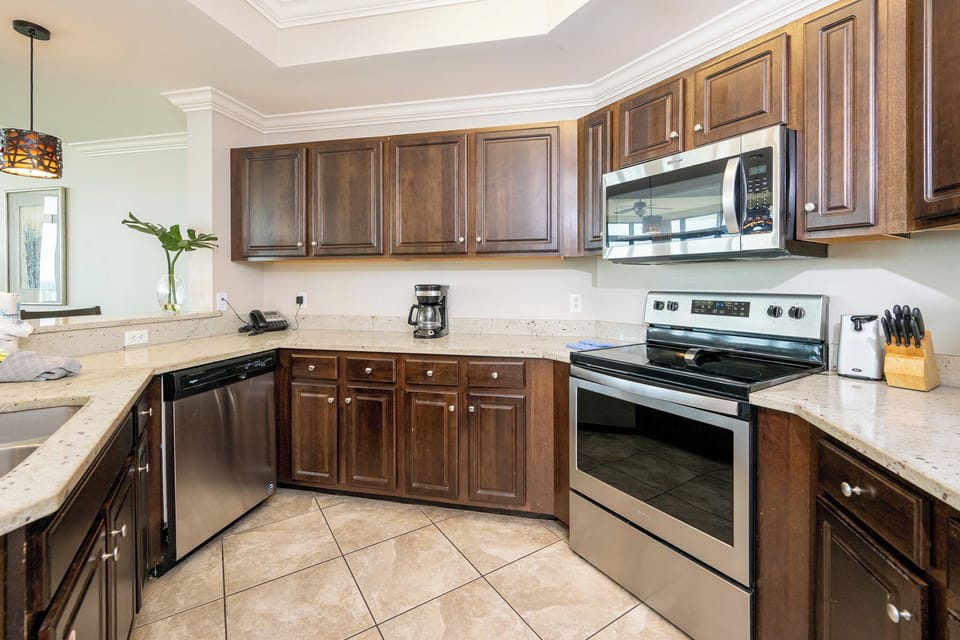 Whip up your favorite meals in this inviting kitchen, where sleek counters and ample cabinetry enhance your cooking vibe