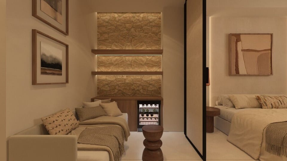 Spacious bedroom featuring sofa, elegant bed, and minibar for guest convenience