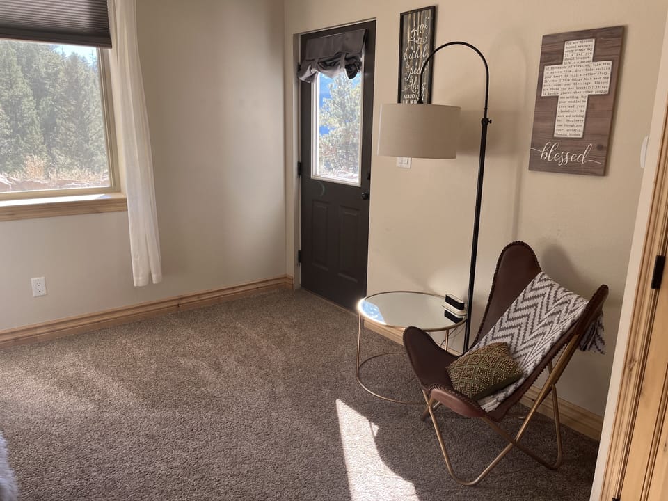 Bedroom #4 downstairs.  Sitting area and door to trampoline.