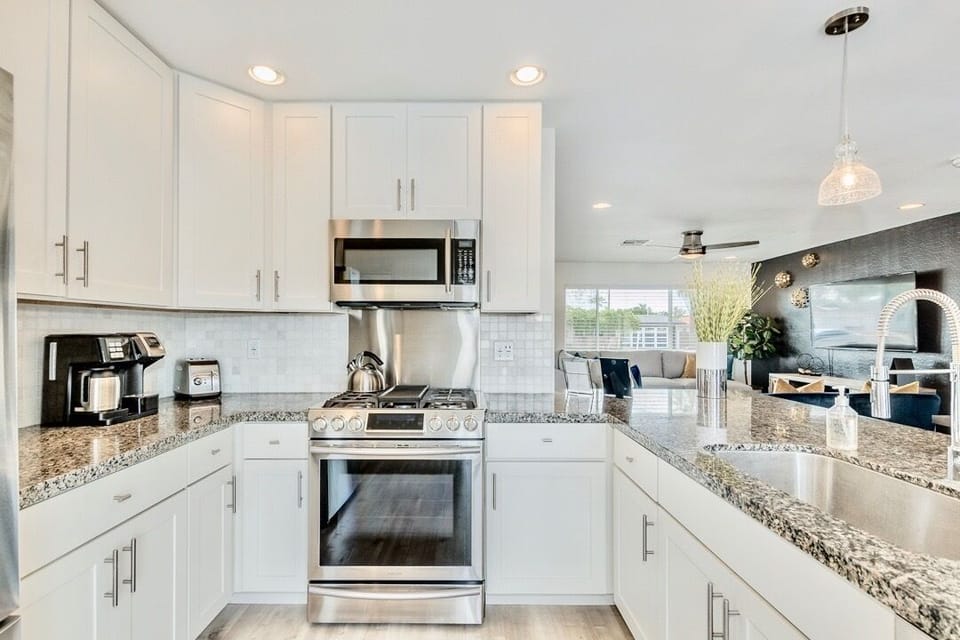 Modern kitchen with stainless steel appliances and large peninsula that seats 4