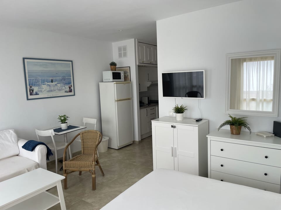 Studio, Sea View | Living area | Flat-screen TV