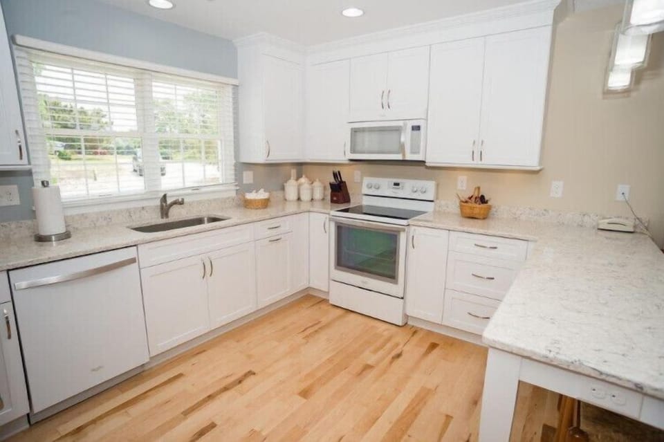 Whip up your favorite meals in this bright, fully equipped kitchen with granite countertops, modern appliances, and ample cabinet space—perfect for your vacation stay.