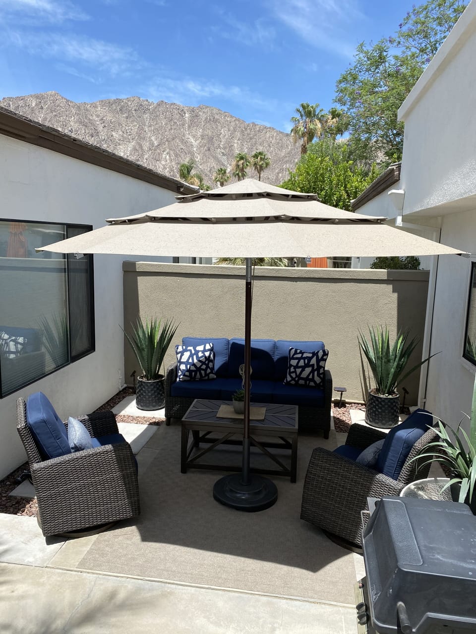 Front courtyard seating area with BBQ