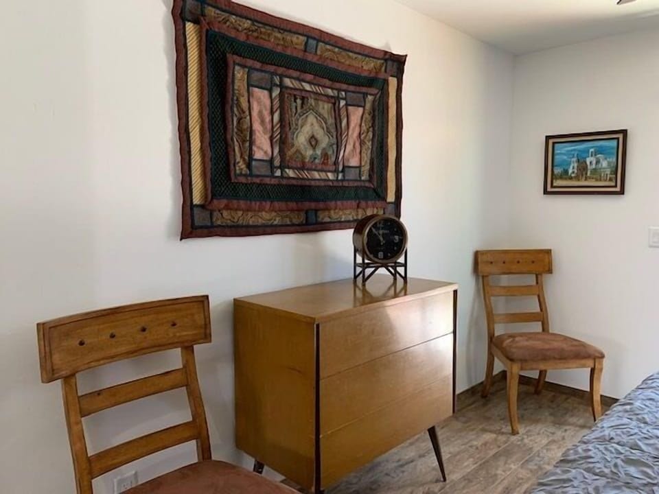 Close up of back wall with original artwork and wall hanging.