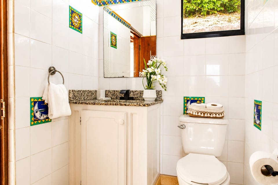 Bright and airy bathroom with natural light and refreshing shower.
