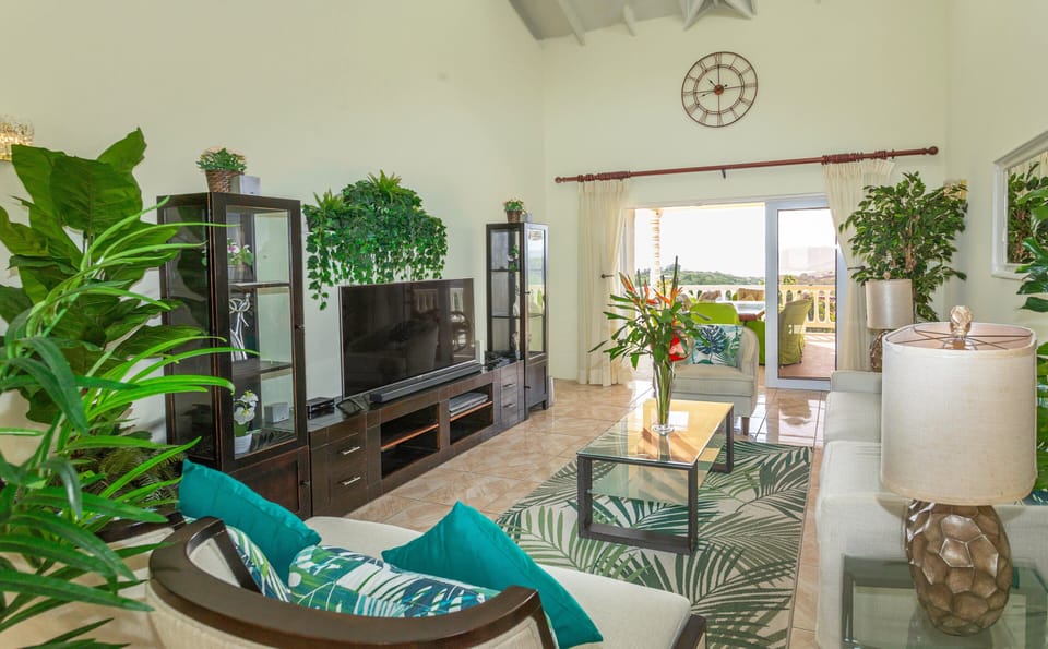 Main Living Room, tastefully decorated.  Smart TV and ceiling fan.  Opens up to a balcony with gorgeous views.