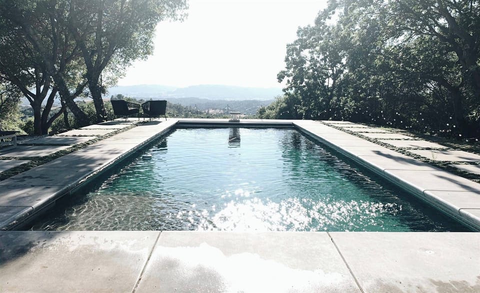 Hilltop pool with skyline views towards the valley.
