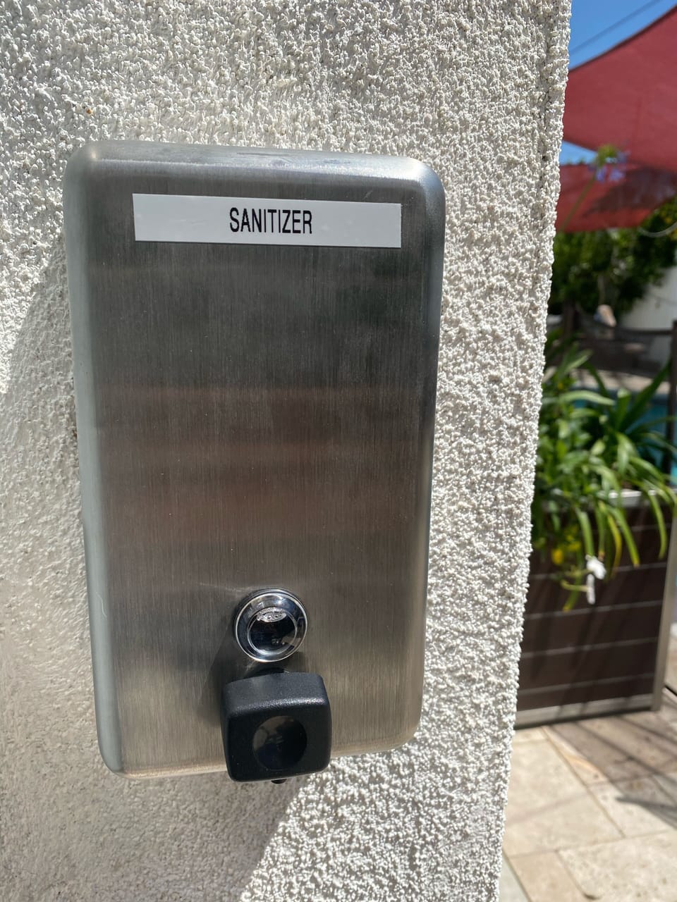 Hand sanitizer by the entrance door.  Please use it before opening the door. 