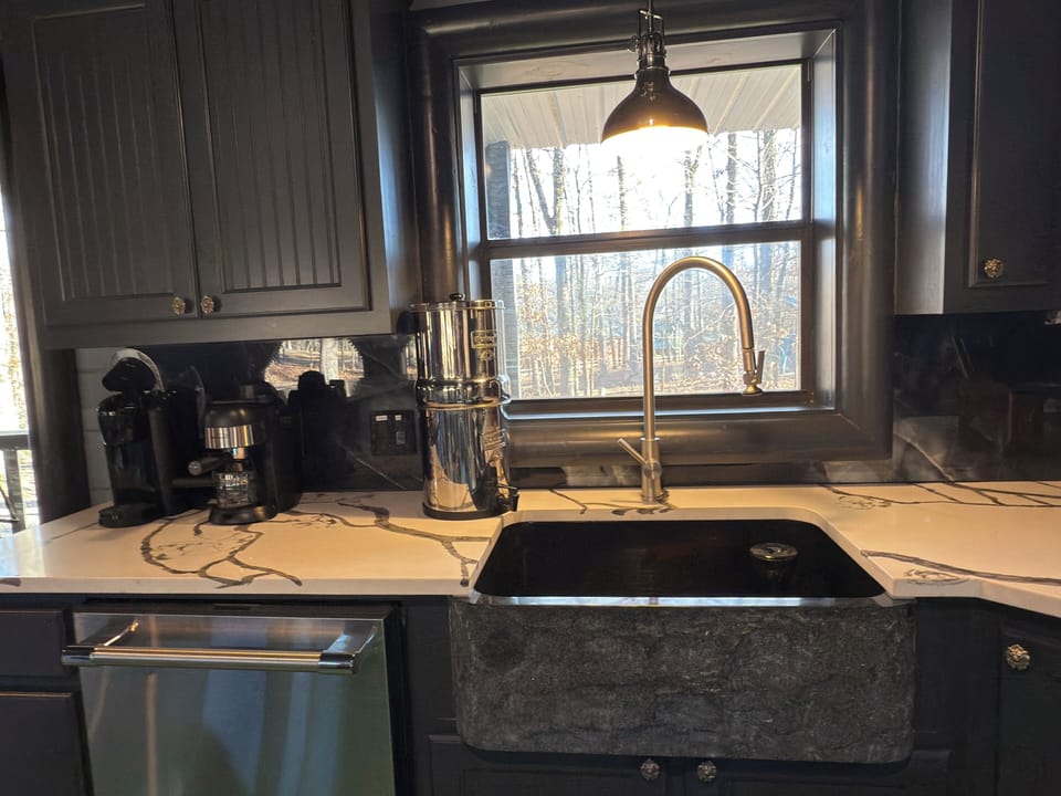 Your gourmet kitchen features stunning quartz countertops, granite farmhouse sink, and forest views that inspire cooking adventures.