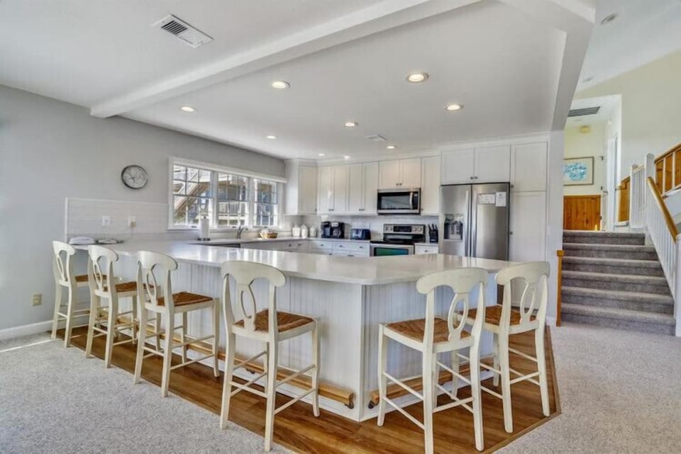 Gather with loved ones in this bright, spacious kitchen featuring a grand island perfect for morning coffee or meal prep. Stainless-steel appliances and ample counter space make cooking feel effortless and enjoyable.