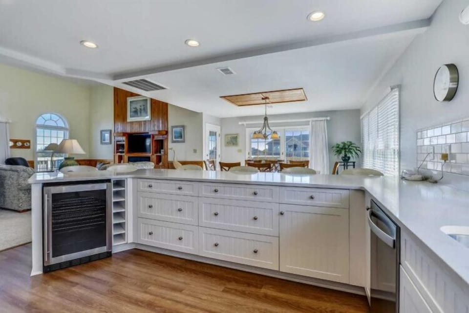 A bright, open-concept kitchen and living area invites you to cook, entertain, and relax. Custom cabinetry, modern appliances, and sleek countertops blend seamlessly with sunlit gathering spaces.