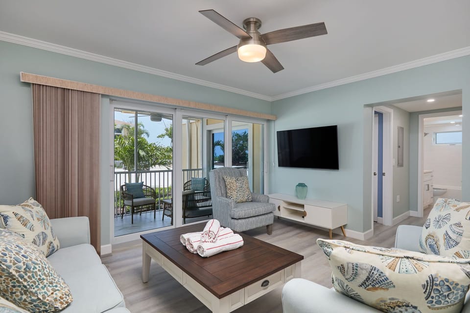 Fully equipped kitchen, expansive living room with comfy furniture, and walk out ground level patio