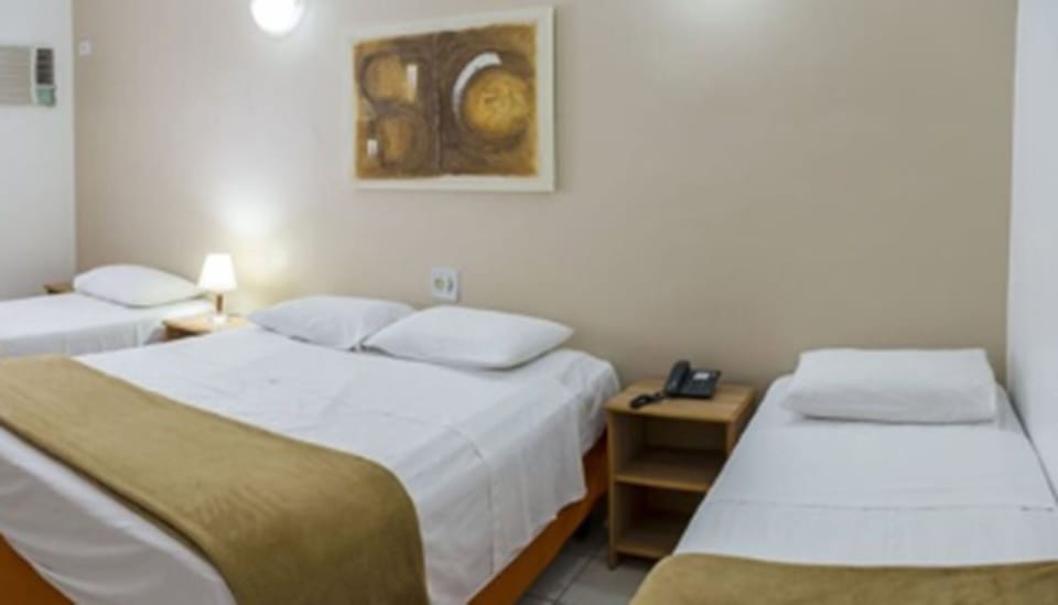 Family Room | Minibar, in-room safe, desk, bed sheets