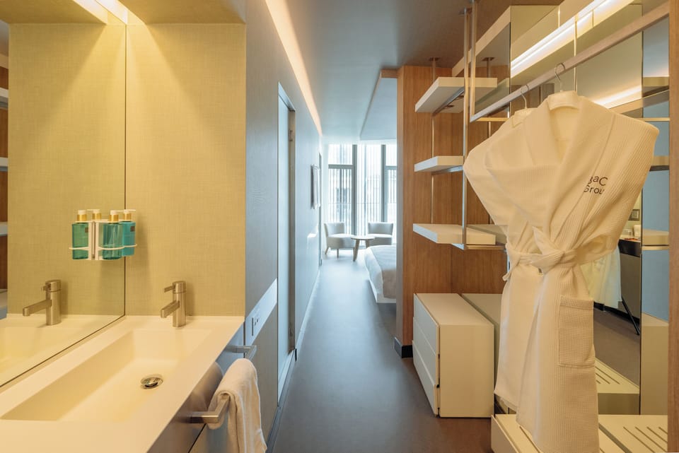 Deluxe Room | Bathroom | Shower, rainfall showerhead, designer toiletries, hair dryer