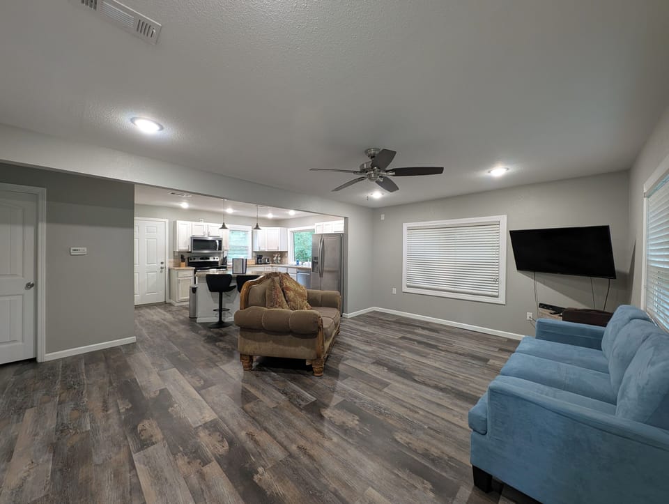 interior, indoor, kitchen, couch, living area, television, refrigerator