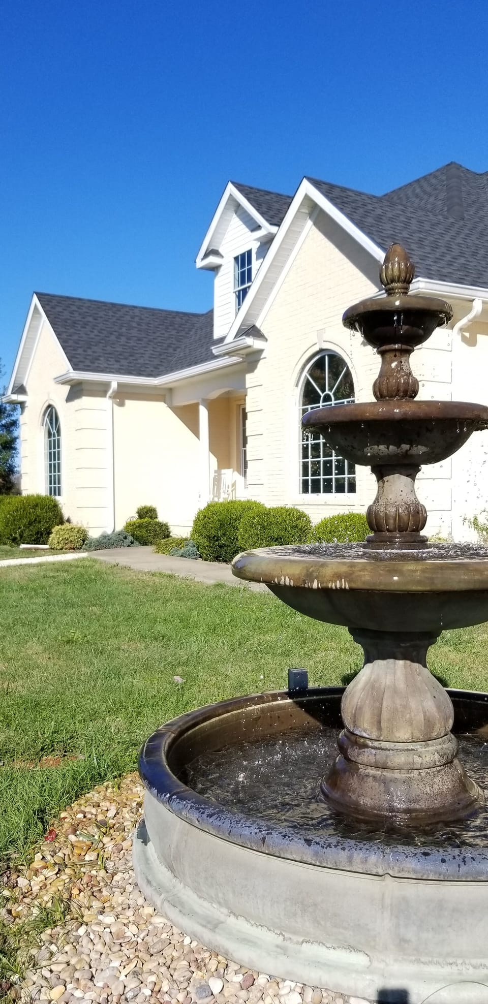 Front of house with water fountain