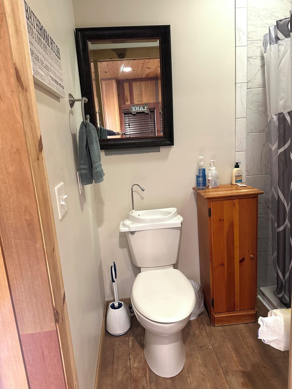Bathroom with stand up shower only no tub. Small unique sink. 