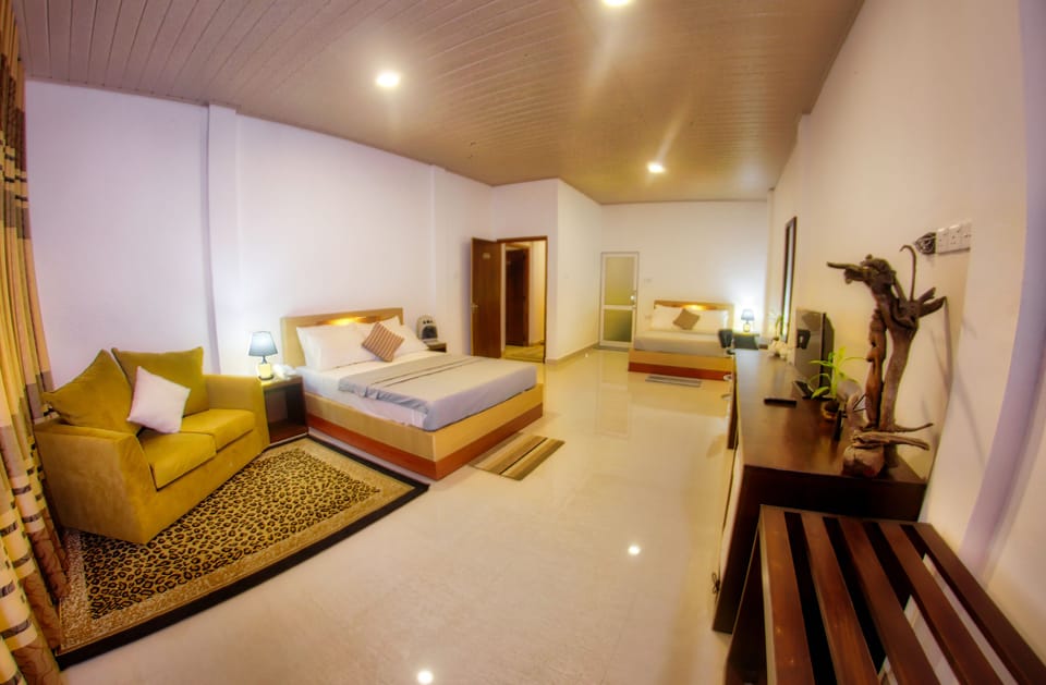 Superior Triple Room | Minibar, in-room safe, desk, iron/ironing board