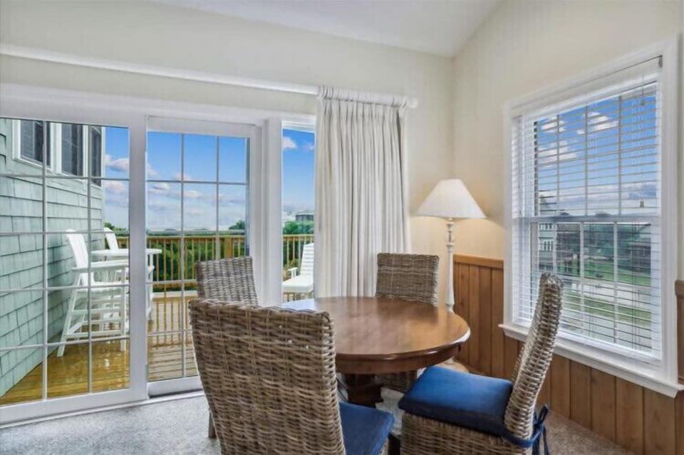 Settle in at your private dining spot with natural light pouring through expansive windows. Step outside to your own balcony and breathe in the coastal views.