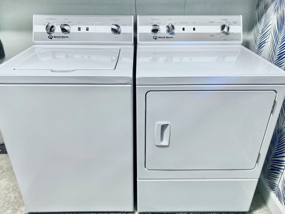 A washer and dryer are available in a large laundry room with a folding table.