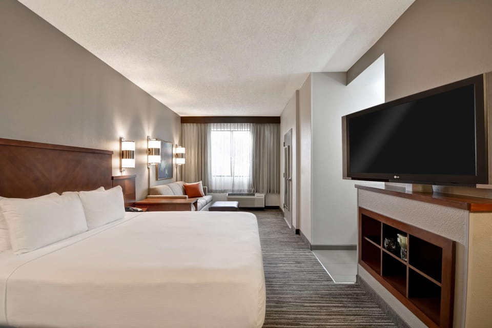 Premium bedding, desk, laptop workspace, blackout drapes