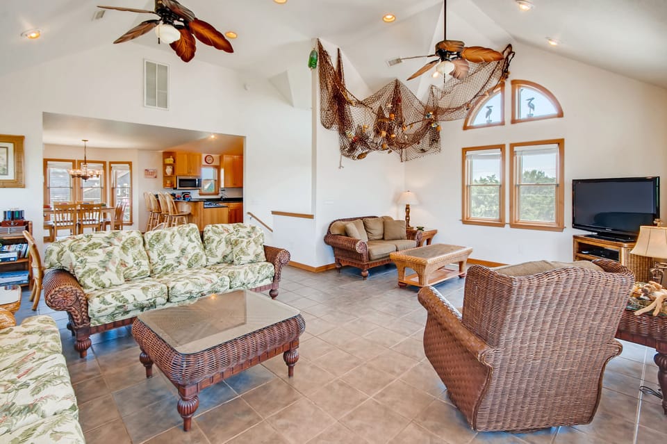 Gather the crew in the spacious great room — island flair, comfortable furnishings, plus a game table for hours of fun and a TV with Blu-ray for entertainment.