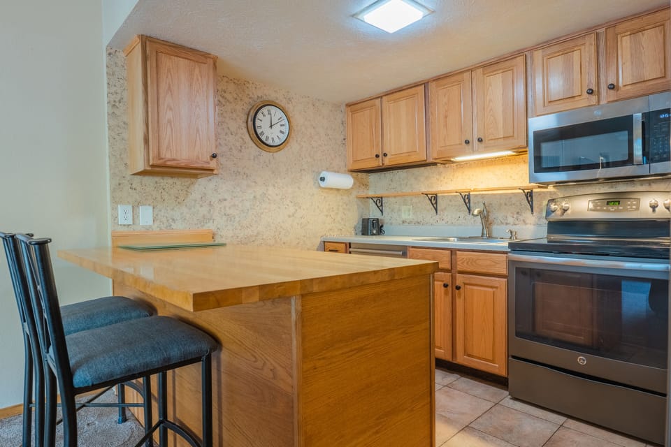 Open concept kitchen with bar stool seating area.