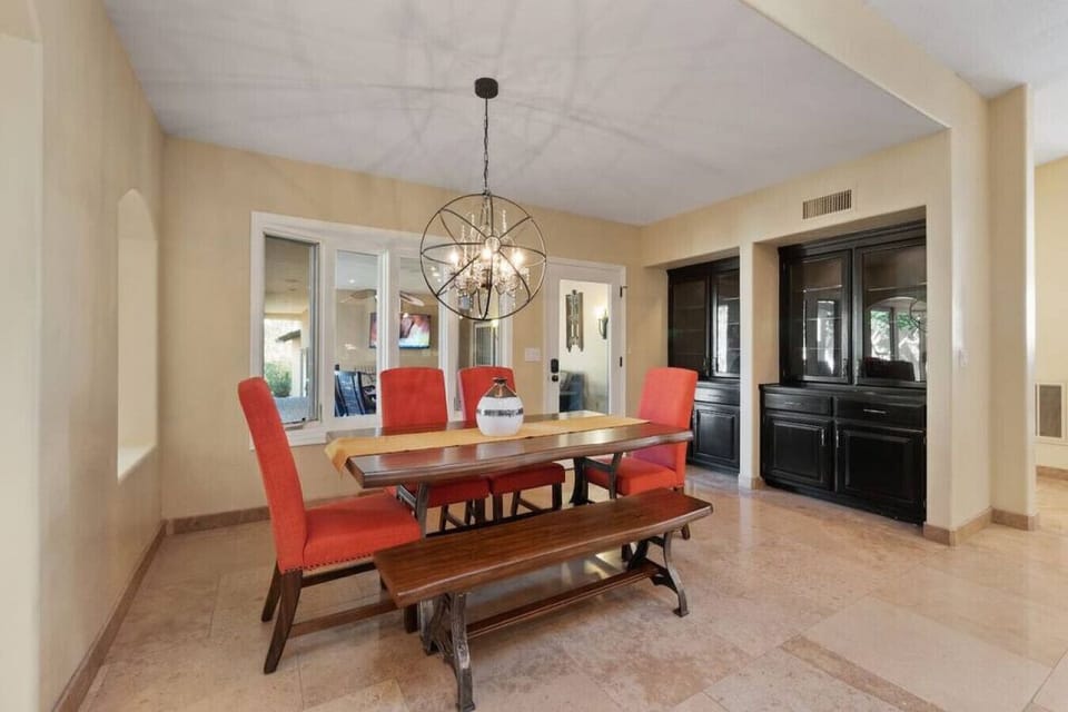 Gather around this beautiful dining table where memorable meals await, featuring vibrant seating and elegant lighting for your perfect dining experience.