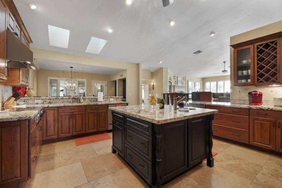 Your gourmet kitchen features granite countertops, rich wood cabinetry, and a spacious island perfect for cooking memorable meals together.