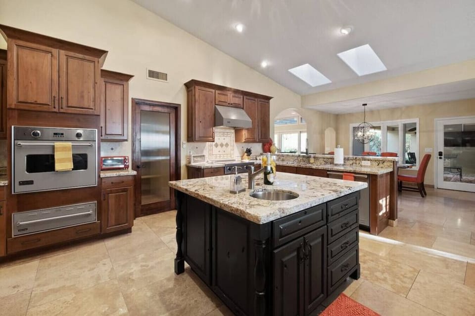 Your spacious gourmet kitchen awaits with granite countertops, premium appliances, and a perfect island for morning coffee or culinary adventures.