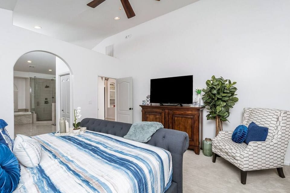 [Bedroom 1] with king size bed, ensuite, and walk-out to the backyard