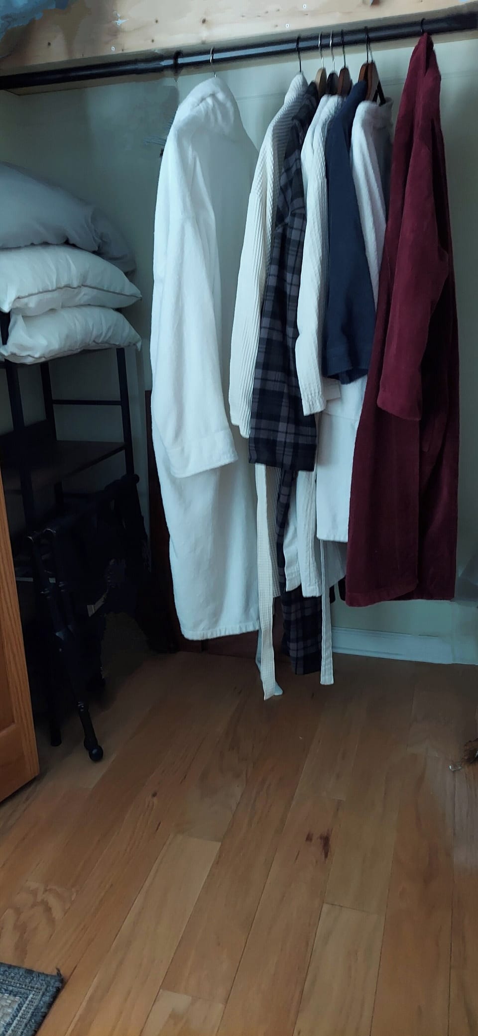 Guest closet with robes and extra bedding