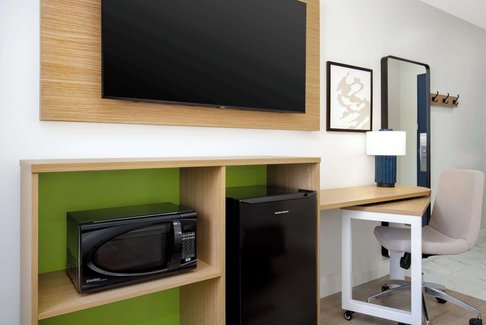 Desk, laptop workspace, blackout drapes, iron/ironing board