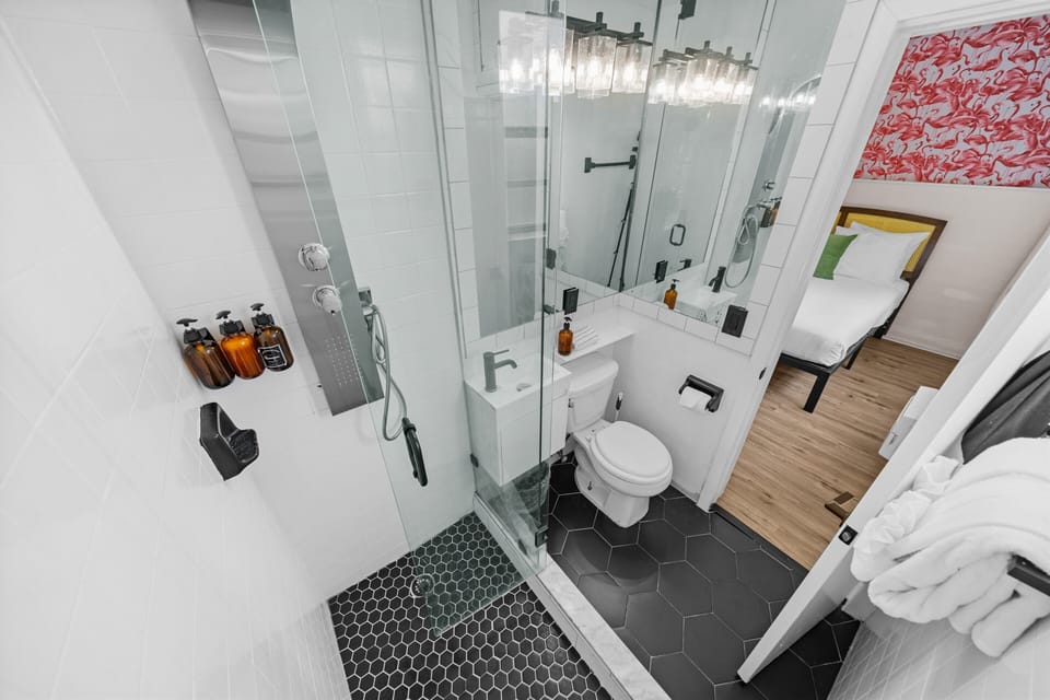 Deluxe Two Queen Beds w/ Kitchenette | Bathroom | Shower, designer toiletries, hair dryer, towels